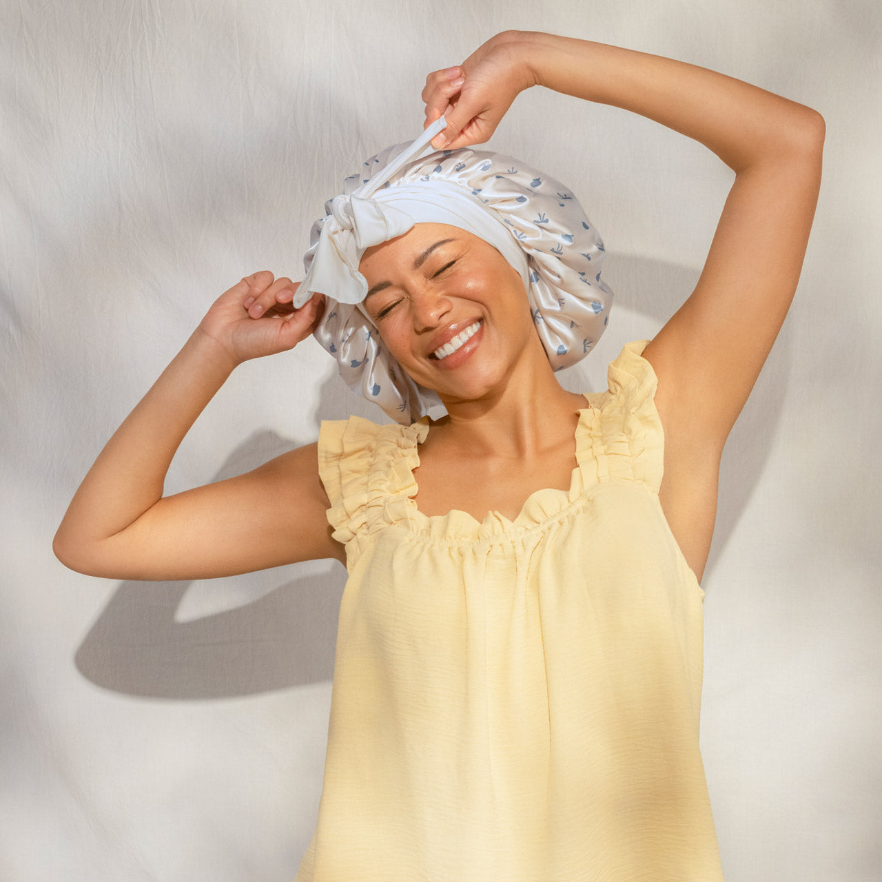 509518-CoastalCottage-OversizedSatinBonnet-PearlizedCream_CoastalBlue-Model-2-1280x1280px.jpg